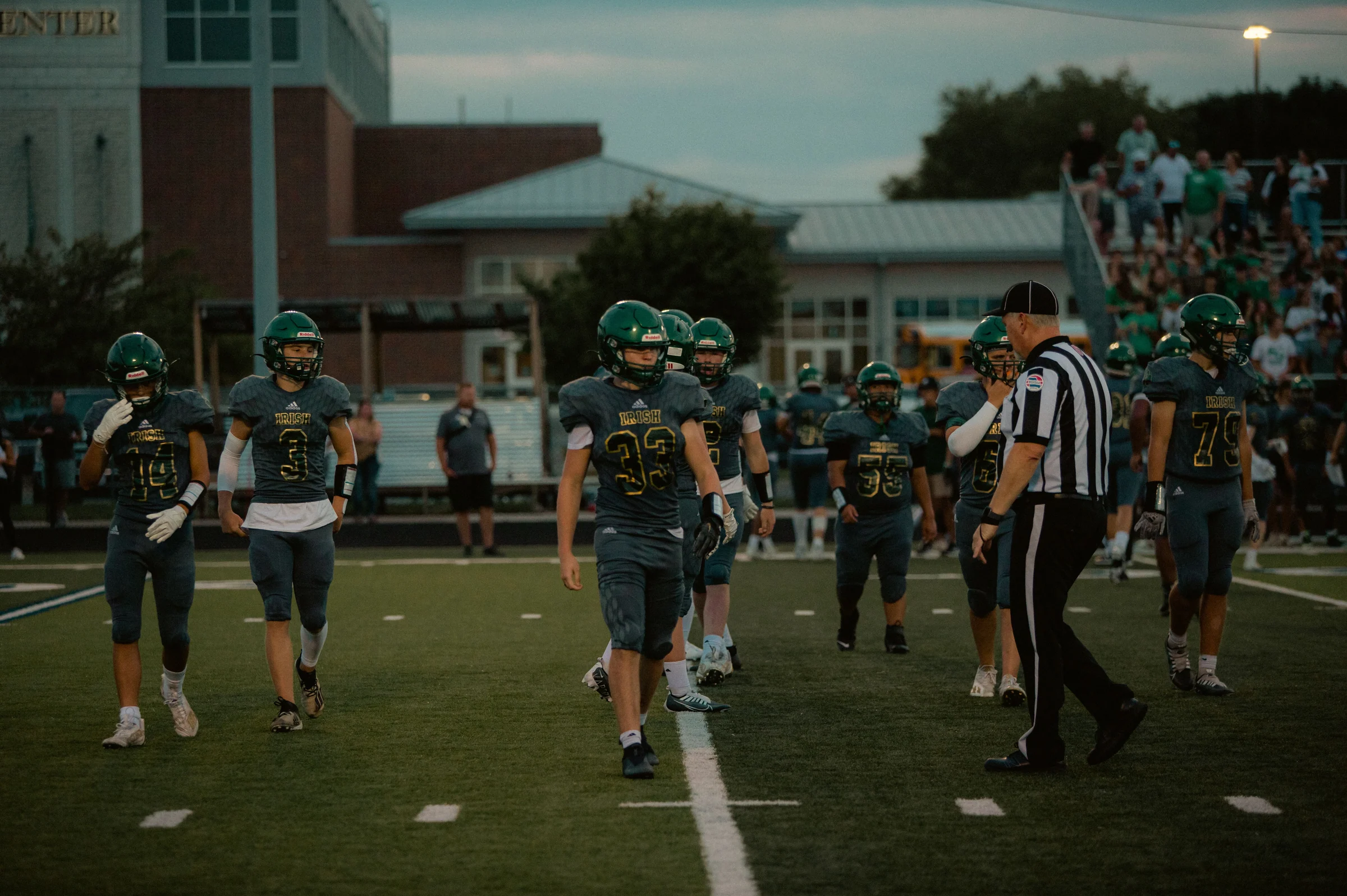 Football players and referee during a high-school game