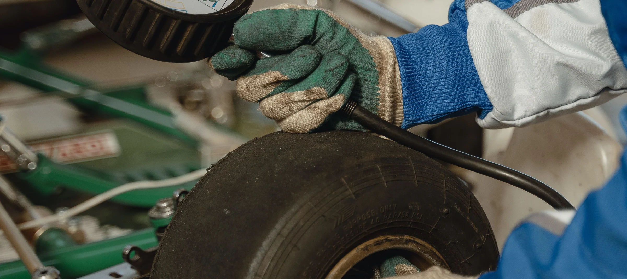 Mechanic checking the pressure of a go-kart tire