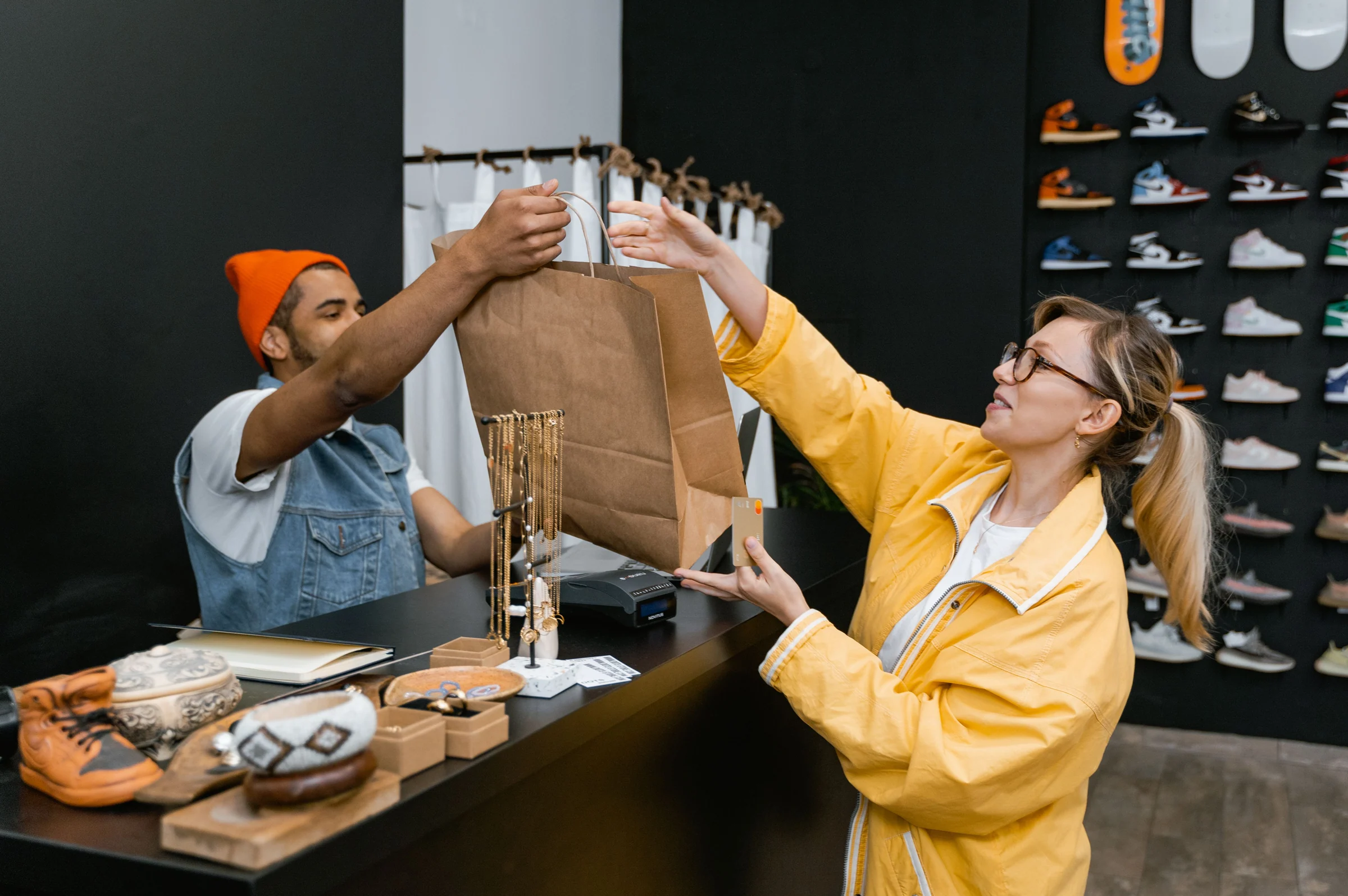 Retail customer and cashier exchanging a shopping bag