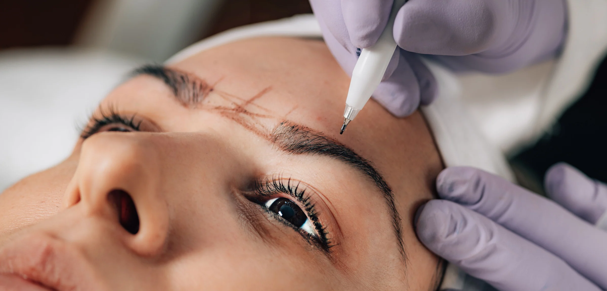 Cosmetologist performing an eyebrow treatment