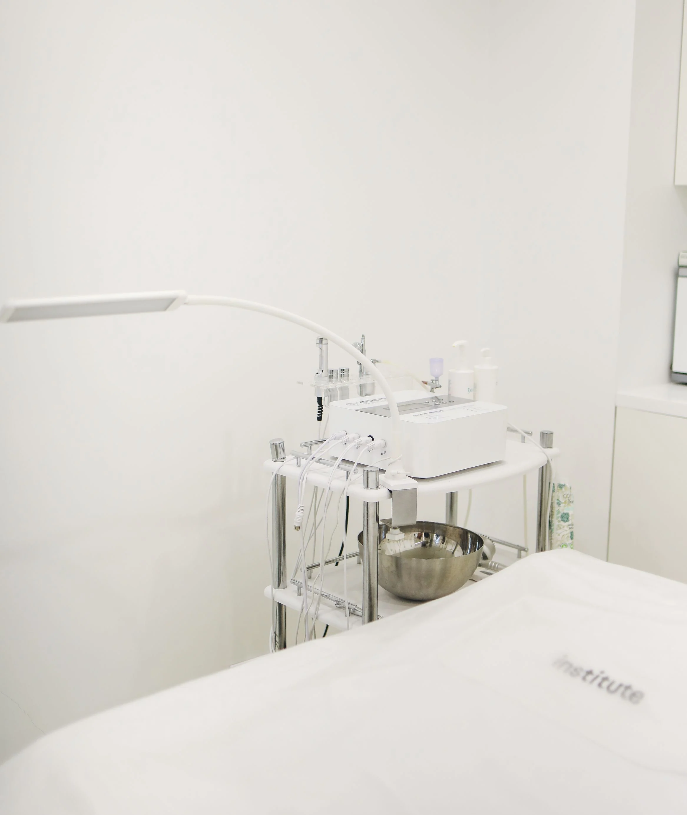 Treatment equipment beside a bed in a beauty salon