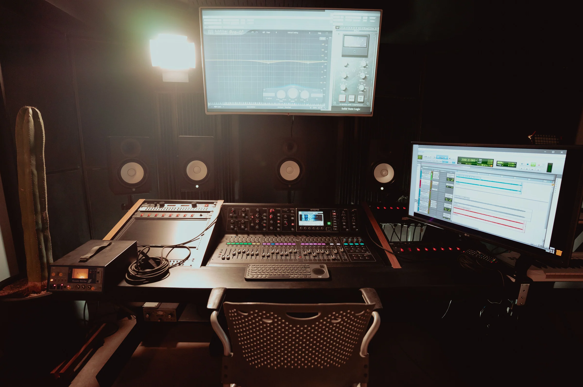 Professional recording studio with mixing console and monitors