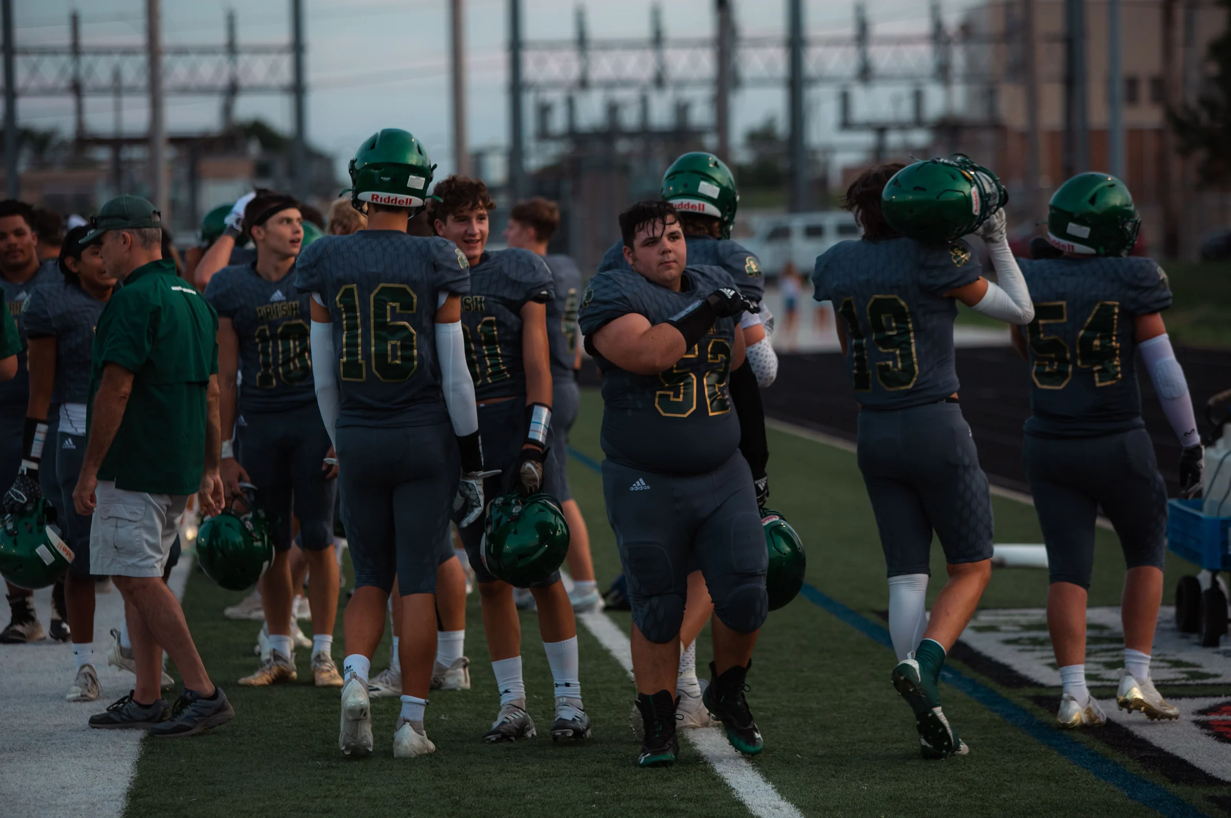 Football players and coaches at the sideline