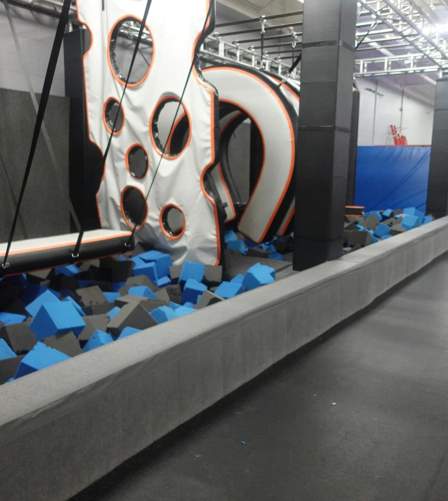 Suspended obstacle course above a foam pit